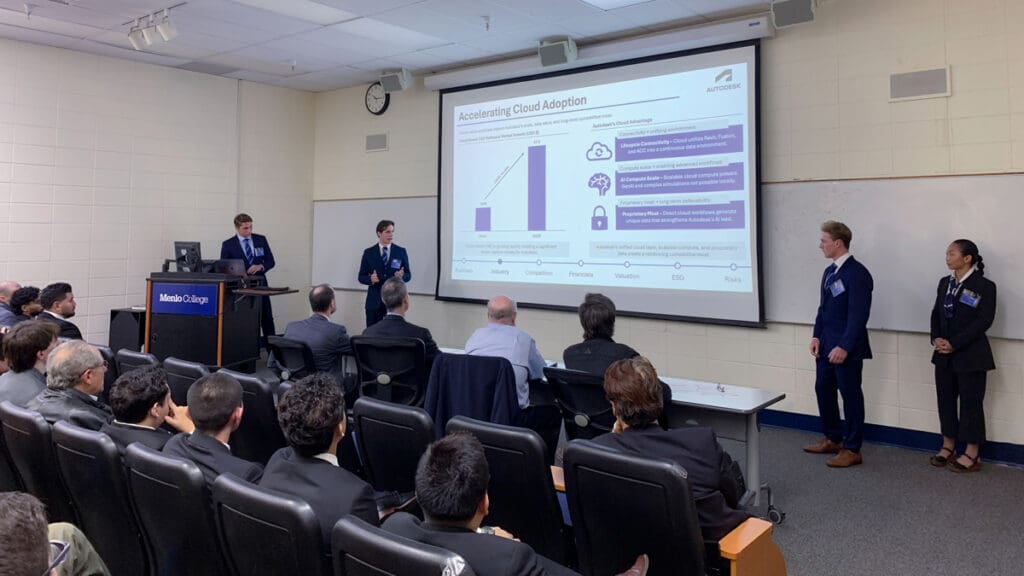 Menlo students present their research to a crowd in a classroom.