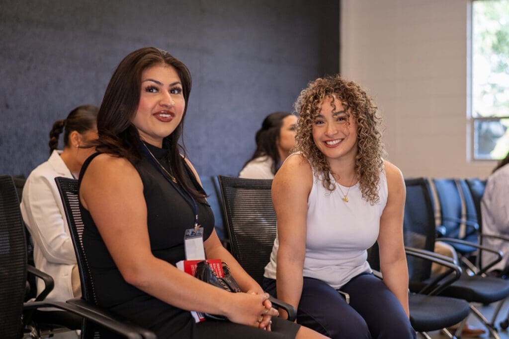 Menlo College students smiling inside a classroom at Menlo College