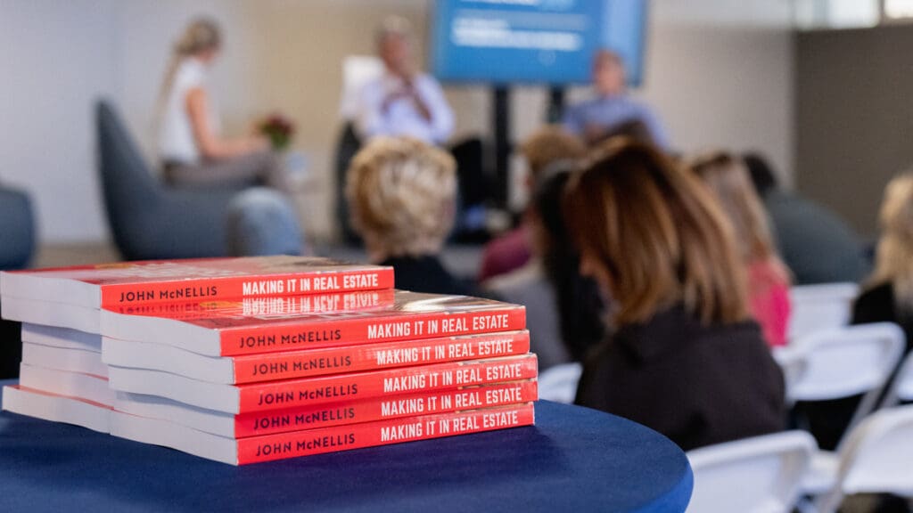 Multiple copies of John McNellis’ book Making It in Real Estate are displayed on a table during Menlo College’s FHC 4.0 Finance Hybrid Conference.