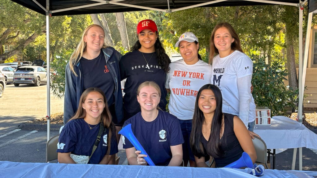 Seven Menlo College Rotaract Club members pose together under an outdoor canopy during a community service event on September 26, 2026.