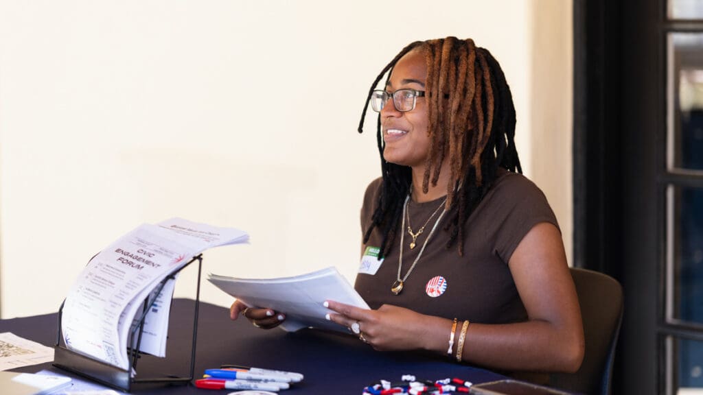 Menlo College student Lesly Bonner, a member of the Civic Engagement Coalition, checks in guests at the Civic Engagement Forum inside the Russell Center on October 7, 2026.