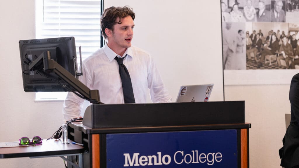 Menlo College student Orion Jenkins-Schell speaks from a podium while moderating the Civic Engagement Forum in the Russell Center on October 7, 2026.