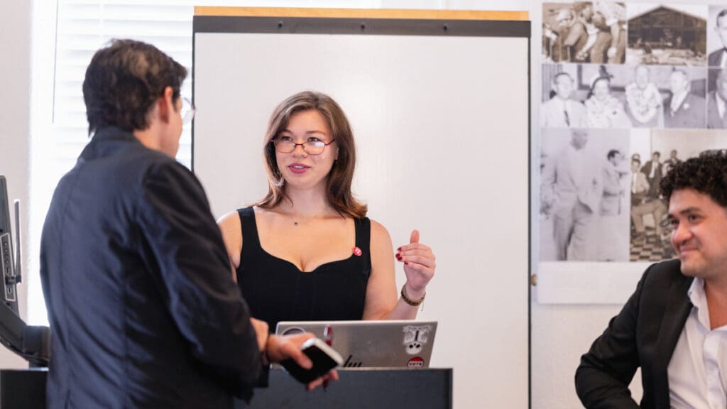 Menlo College student and Civic Engagement Coalition member Brooklyn Small speaks with a fellow participant near the podium during the Civic Engagement Forum in the Russell Center on October 7, 2026.